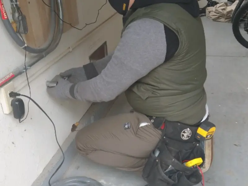 Electrician performing outlet wiring in a Foothill Farms garage
